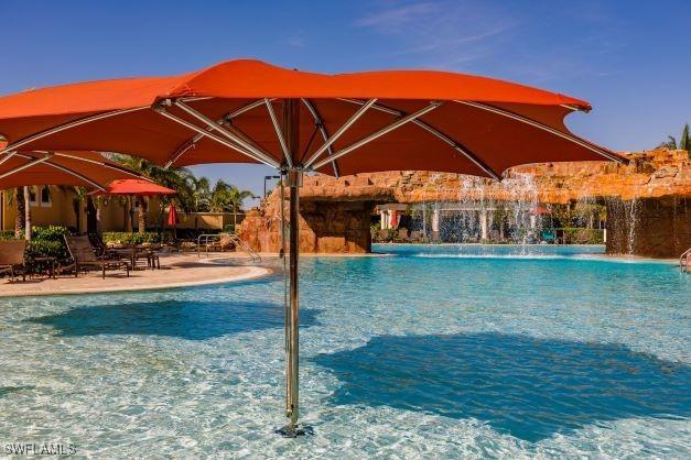 view of swimming pool with pool water feature