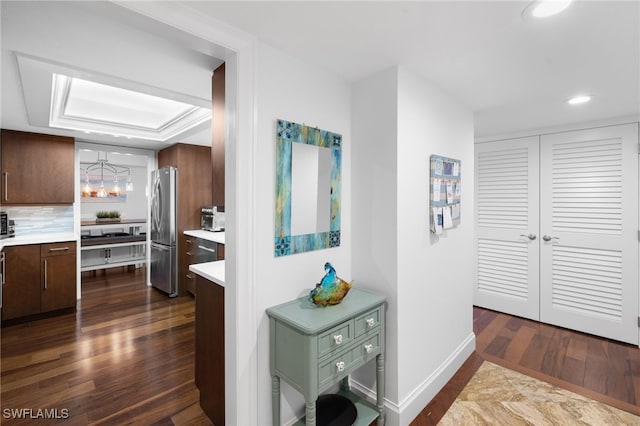 hall featuring recessed lighting, baseboards, and dark wood-style flooring