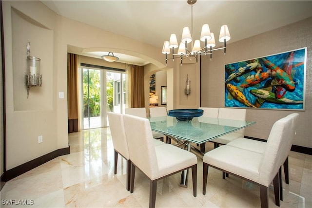 dining area featuring an inviting chandelier