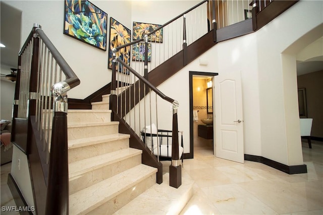 staircase featuring a high ceiling