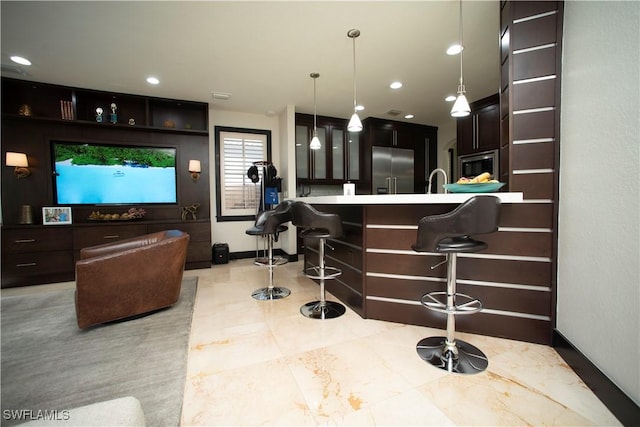 bar with pendant lighting and stainless steel appliances