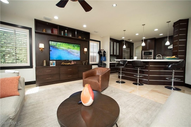 interior space with light tile patterned floors and ceiling fan