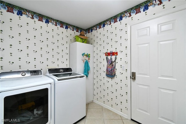 washroom featuring separate washer and dryer and light tile patterned floors