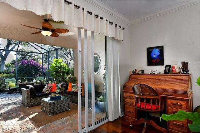 interior space with ornamental molding and ceiling fan