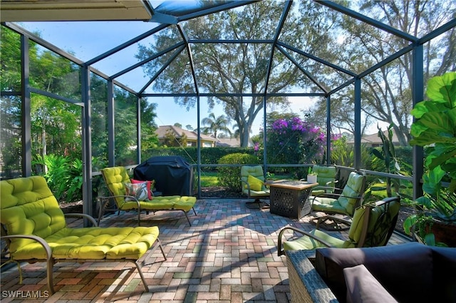 view of patio / terrace featuring area for grilling, an outdoor fire pit, and glass enclosure