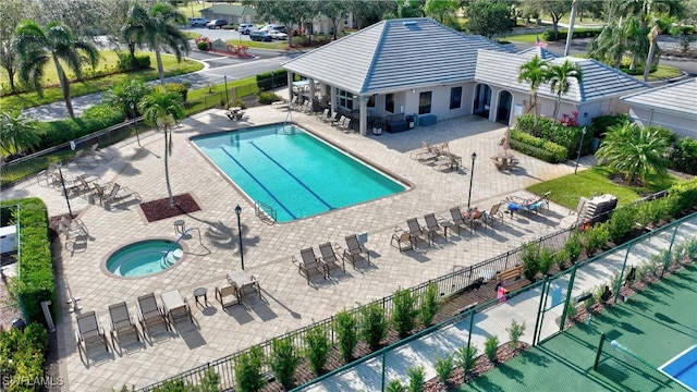 view of swimming pool with a patio area and a hot tub