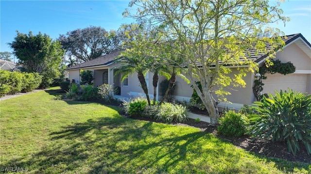 view of home's exterior featuring a yard and a garage