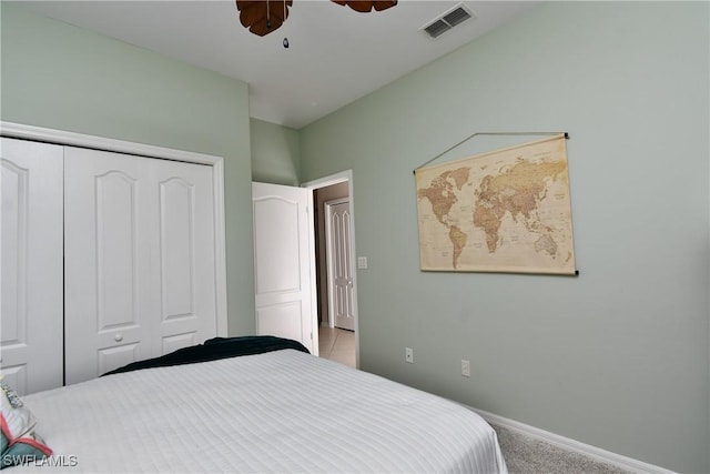 bedroom with light carpet, a closet, and ceiling fan