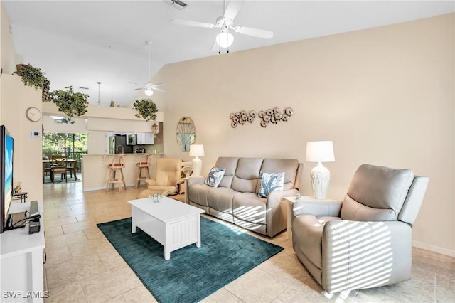 tiled living room with ceiling fan and lofted ceiling