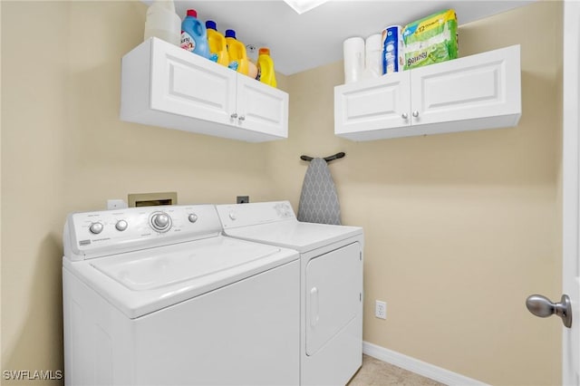 washroom with separate washer and dryer and cabinets