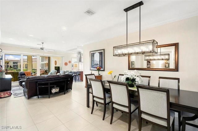 dining area featuring light tile patterned floors, ornamental molding, and ceiling fan