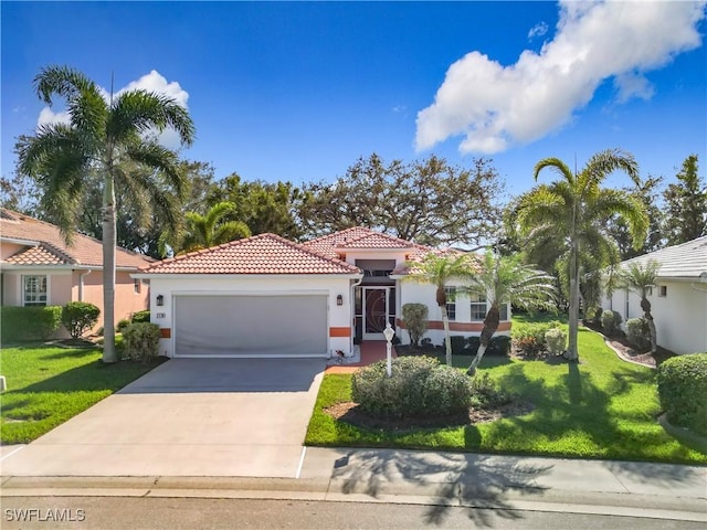 mediterranean / spanish home with a front yard and a garage