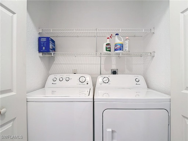 washroom with washing machine and clothes dryer