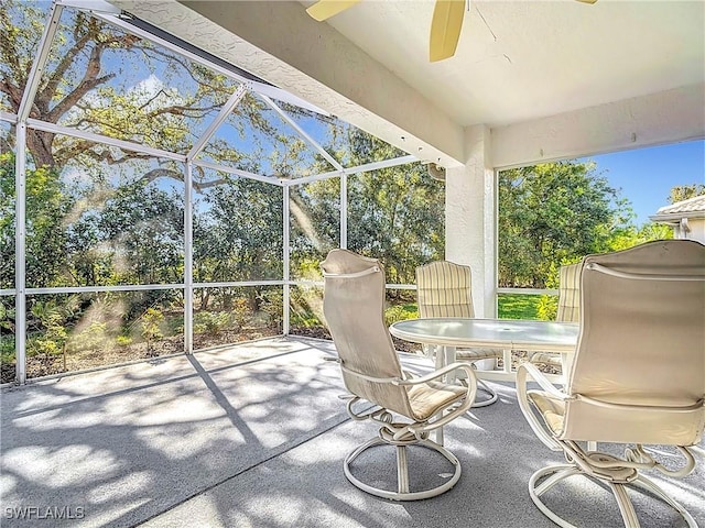 unfurnished sunroom featuring ceiling fan