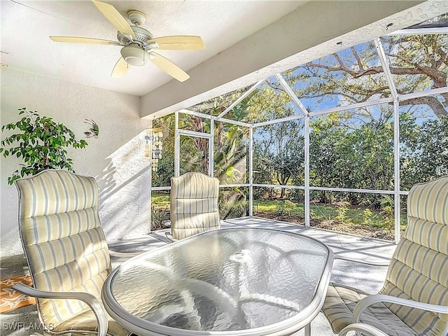 view of patio / terrace with ceiling fan and a lanai