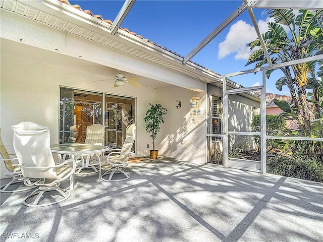 view of patio with ceiling fan and a lanai