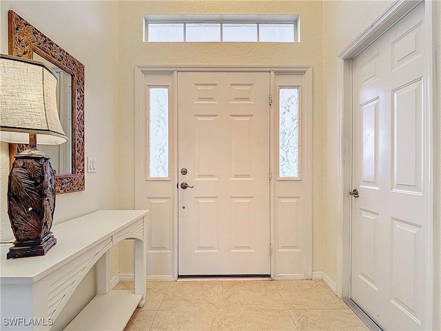 foyer entrance with light tile patterned flooring