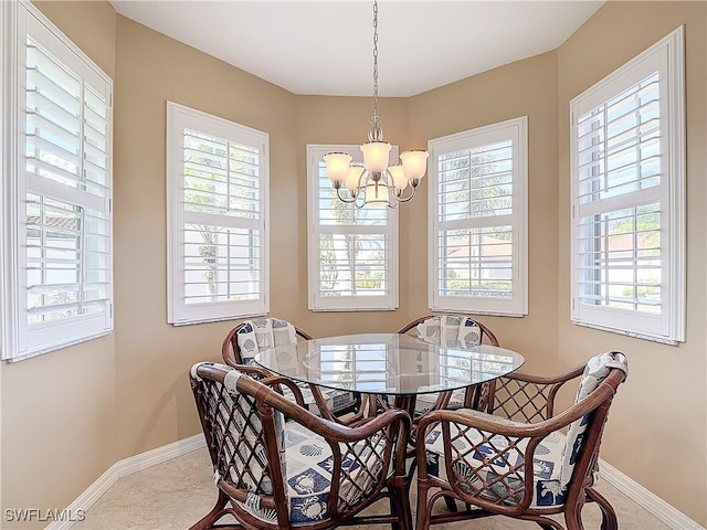 tiled dining space featuring an inviting chandelier