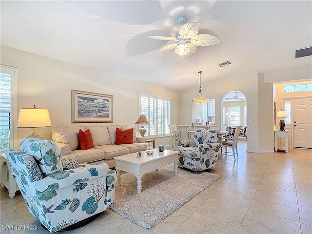 living room featuring a wealth of natural light, ceiling fan, and light tile patterned floors