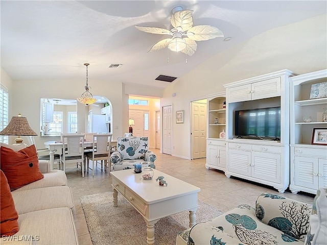 tiled living room with built in shelves, ceiling fan, and lofted ceiling