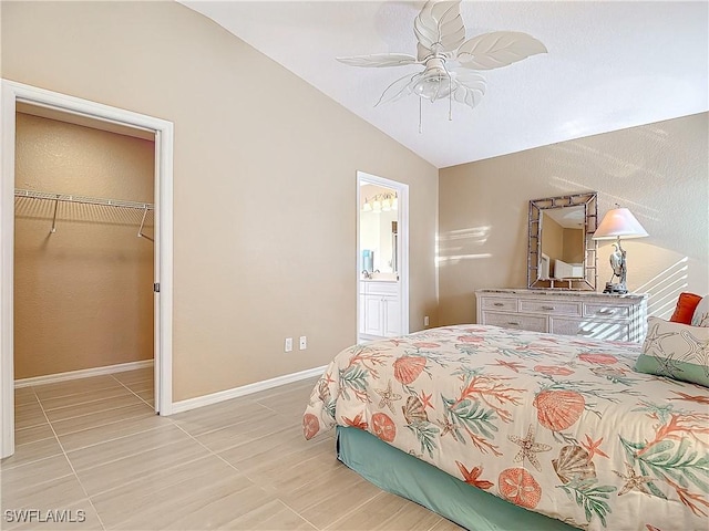 bedroom with ceiling fan, light tile patterned floors, a spacious closet, a closet, and lofted ceiling