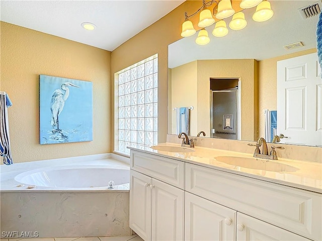 bathroom featuring tile patterned floors, vanity, plenty of natural light, and plus walk in shower