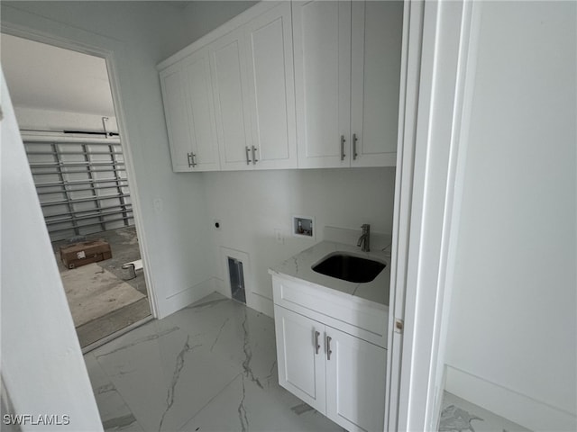 laundry room with electric dryer hookup, cabinets, sink, and hookup for a washing machine