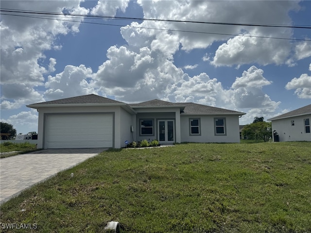 view of front of property with a garage, a front yard, and french doors