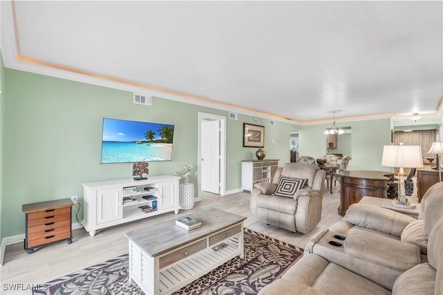 living room featuring ornamental molding and a notable chandelier