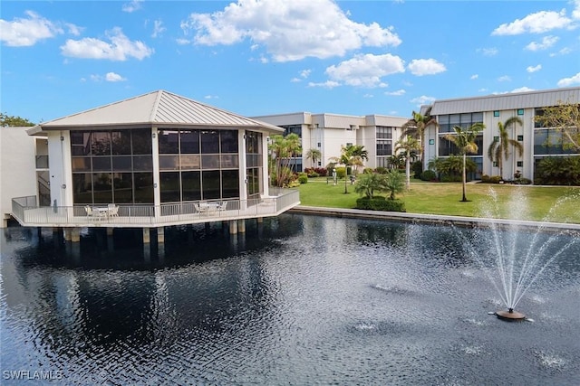 view of pool featuring a water view and a lawn