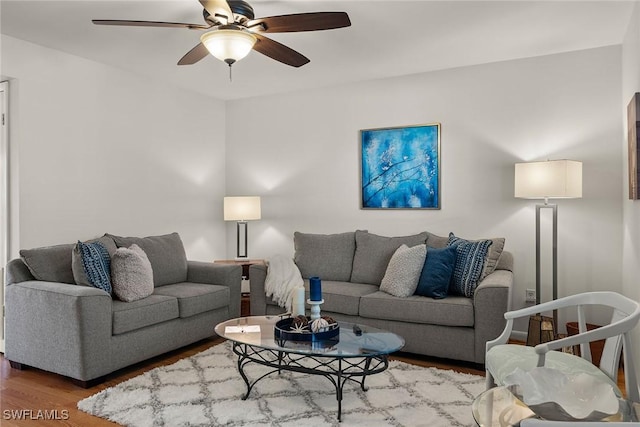 living room featuring wood-type flooring and ceiling fan