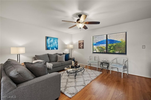 living room featuring ceiling fan and wood-type flooring