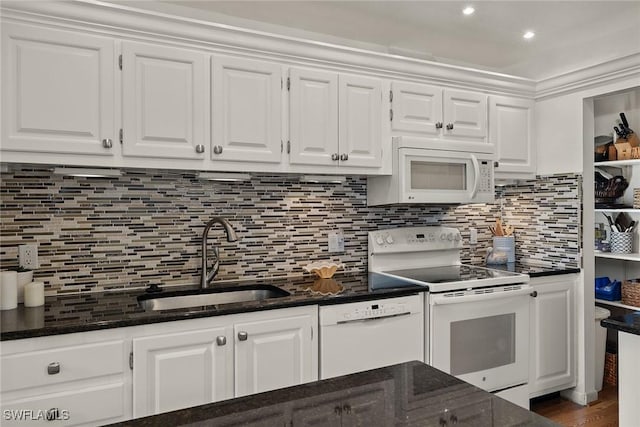 kitchen with backsplash, sink, white cabinets, and white appliances