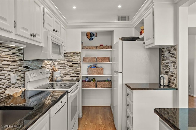 kitchen featuring white appliances, dark stone counters, tasteful backsplash, light hardwood / wood-style floors, and white cabinetry