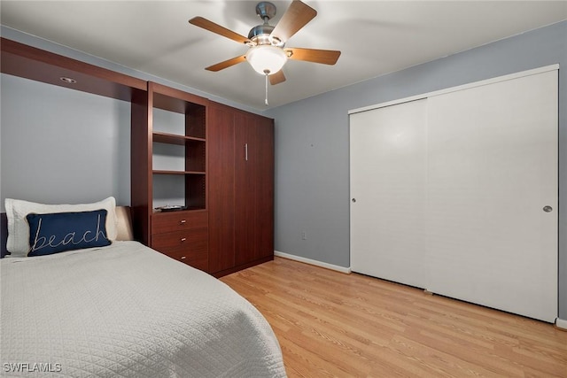 bedroom featuring a closet, light hardwood / wood-style floors, and ceiling fan