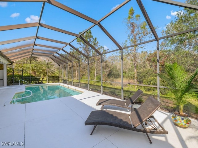 view of swimming pool featuring a lanai and a patio area