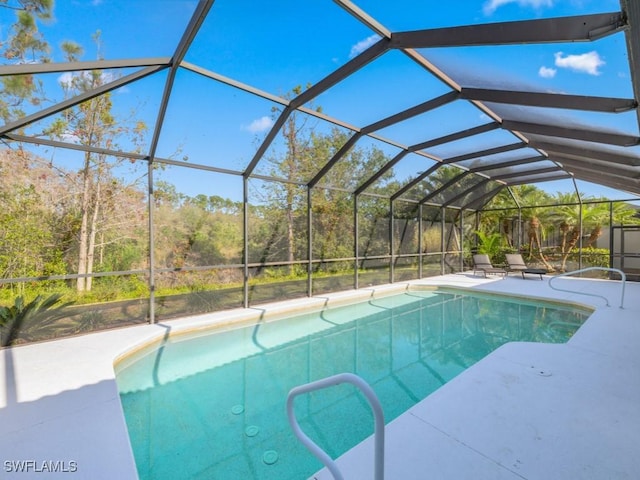 view of swimming pool with a patio and a lanai