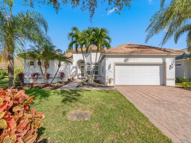 26430 Doverstone St, Bonita Springs, FL 34135 - mediterranean / spanish house featuring a front lawn and a garage