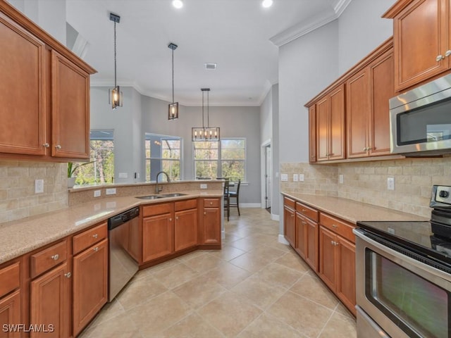 kitchen featuring appliances with stainless steel finishes, decorative light fixtures, ornamental molding, and sink