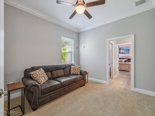 living room featuring ceiling fan, light colored carpet, and ornamental molding