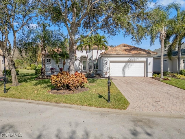 view of front of house with a front lawn and a garage