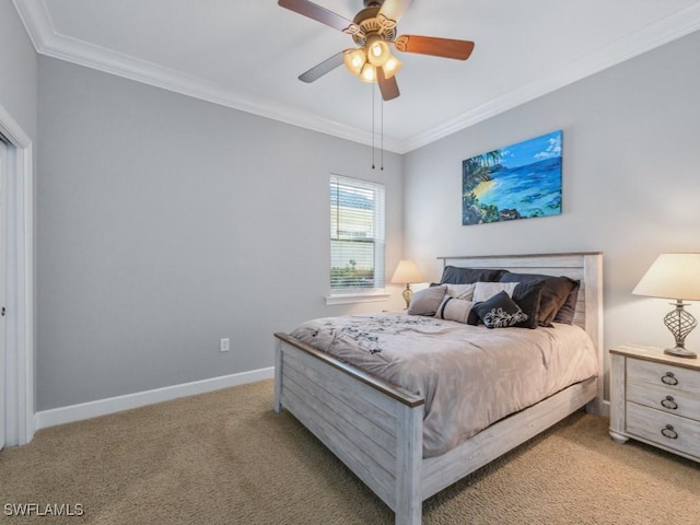 carpeted bedroom with ceiling fan and ornamental molding