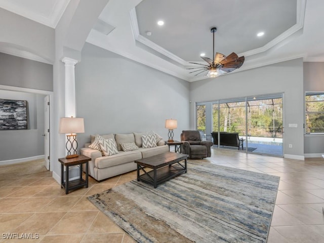 living room with decorative columns, ceiling fan, light tile patterned floors, and ornamental molding