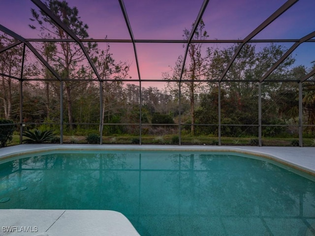 pool at dusk with a lanai