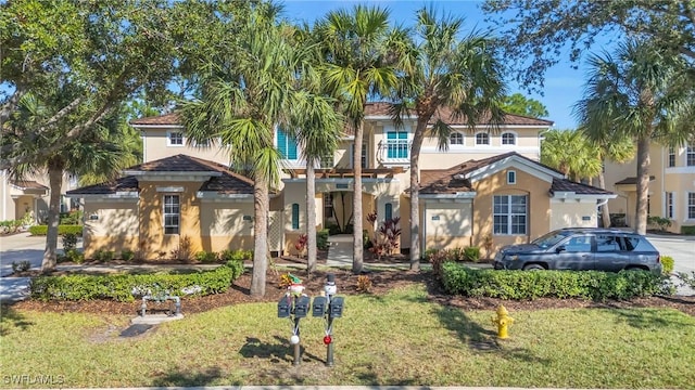 mediterranean / spanish house with a front yard