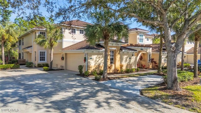 mediterranean / spanish-style house with a garage