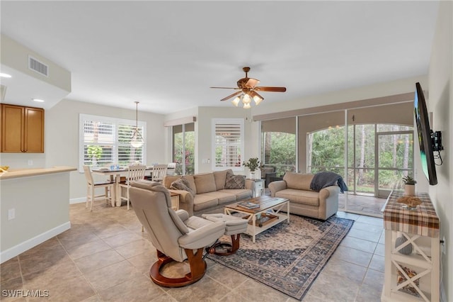 living room featuring light tile patterned floors and ceiling fan