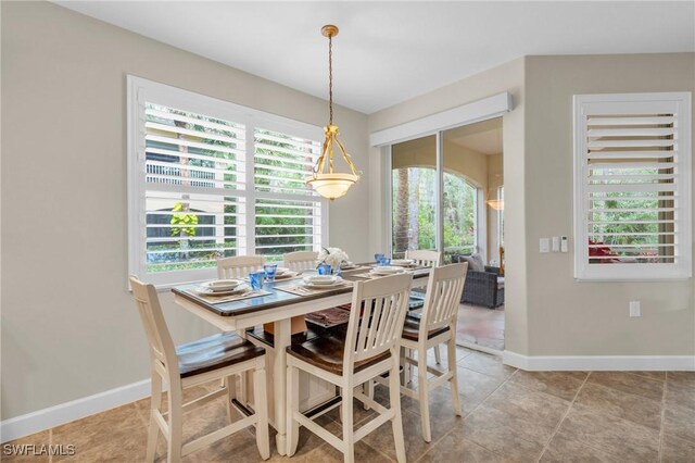 tiled dining area featuring a wealth of natural light