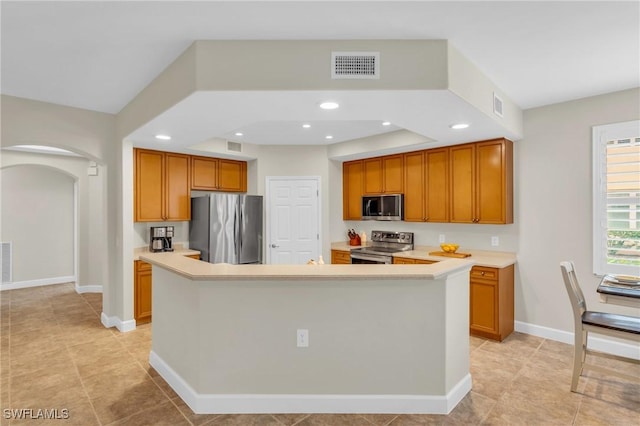 kitchen with stainless steel appliances and an island with sink