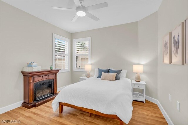 bedroom with wood-type flooring and ceiling fan